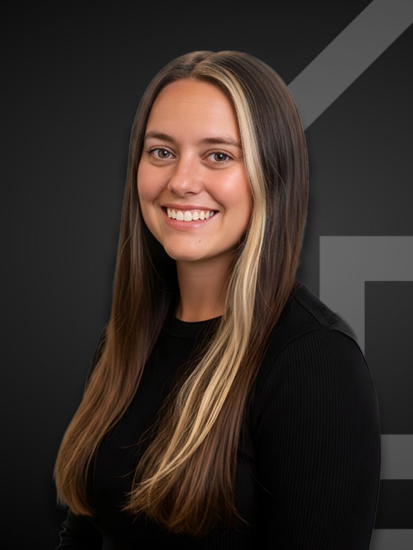 Emilee Myers, Loan Officer at Kash Mortgage Group, smiling against a dark background, showcasing her professional portrait for mortgage services.