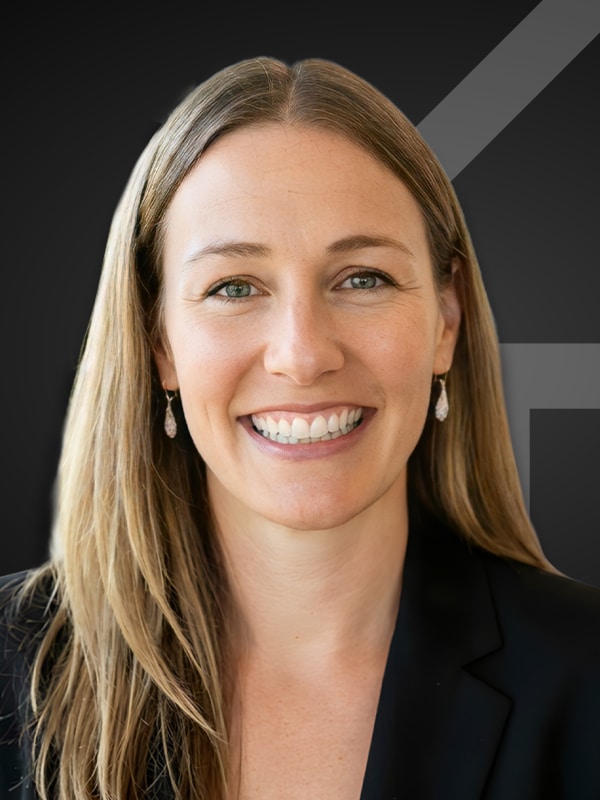 Laurie Snell, smiling professional portrait, mortgage expert and loan officer at Kash Mortgage Group, wearing a black blazer, showcasing a friendly demeanor against a dark background.